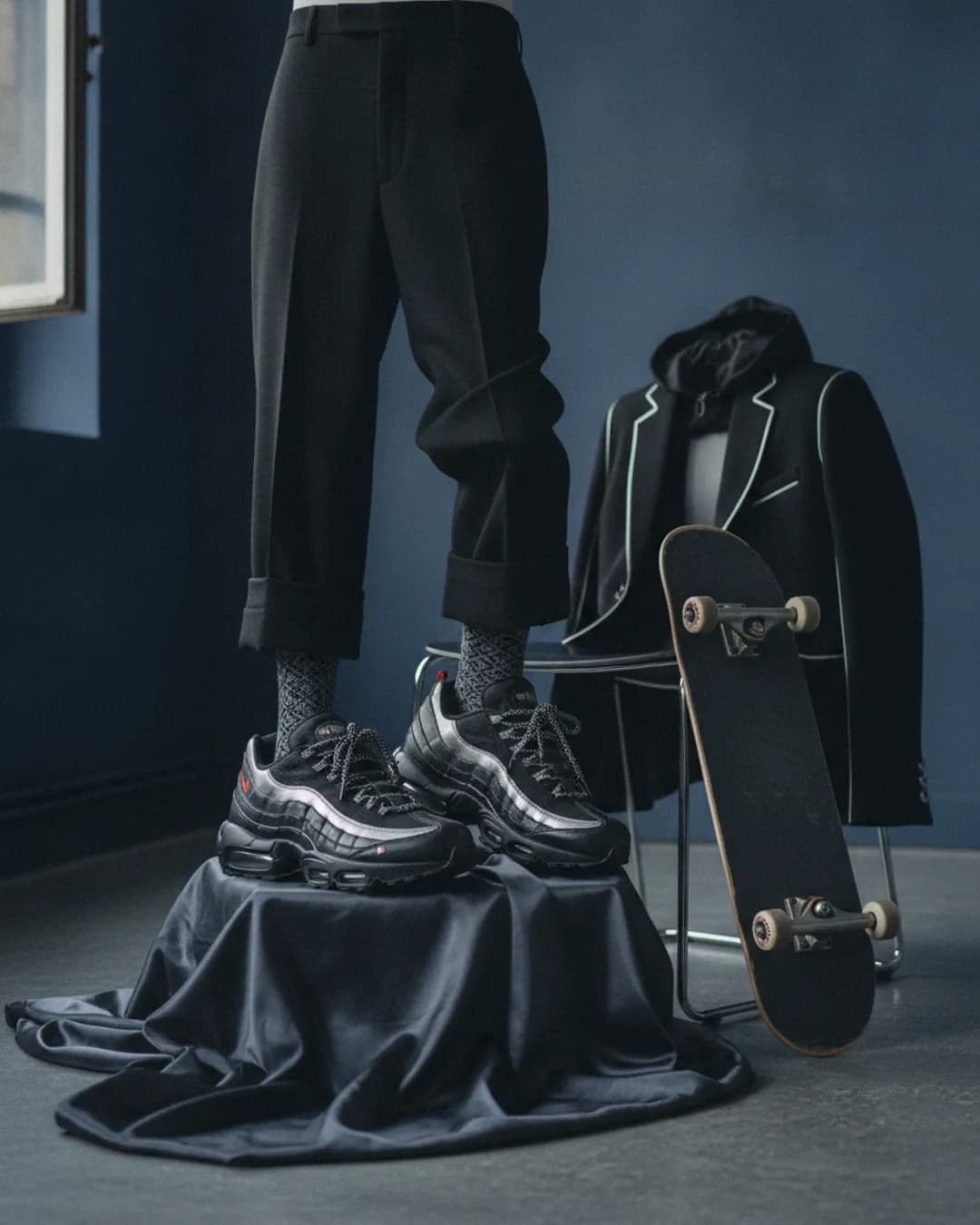 black and metallic sneakers on a dark background